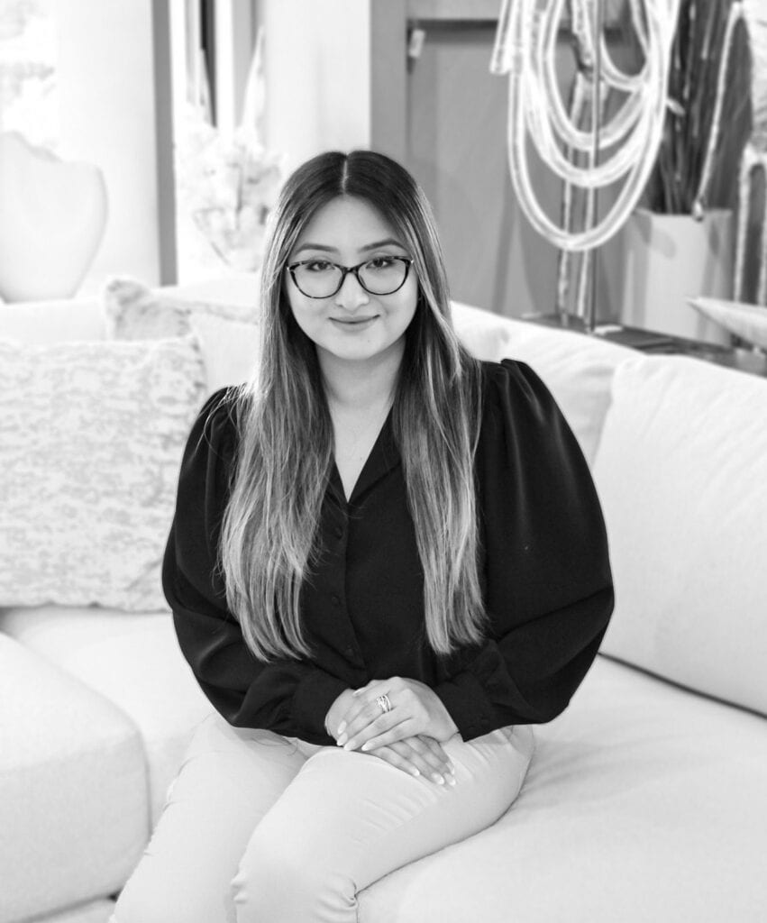 Elegant woman wearing glasses, professional interior design work, Brown Design Group branding.