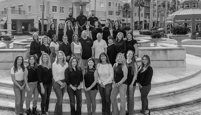 Professional team photo of Brown Design Group in an urban outdoor setting, showcasing expertise in interior and architectural design.