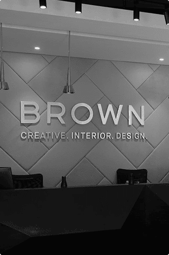Modern interior design office reception with Brown Design Group branding and sleek decor.